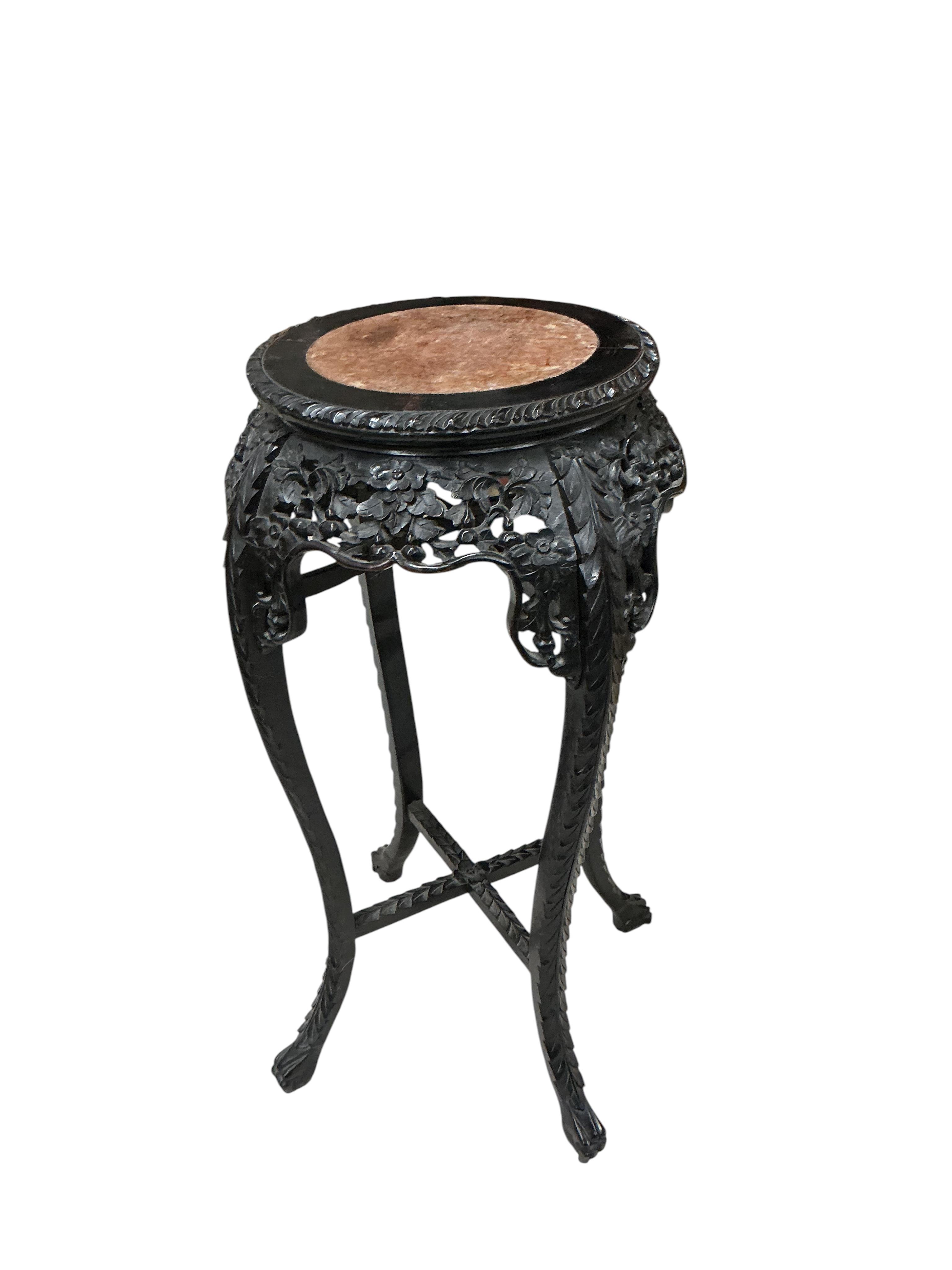 A Chinese circular rouge marble topped carved hardwood vase stand, diameter 44cm, height 91cm